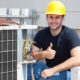 HVAC technician performing maintenance with thumbs up