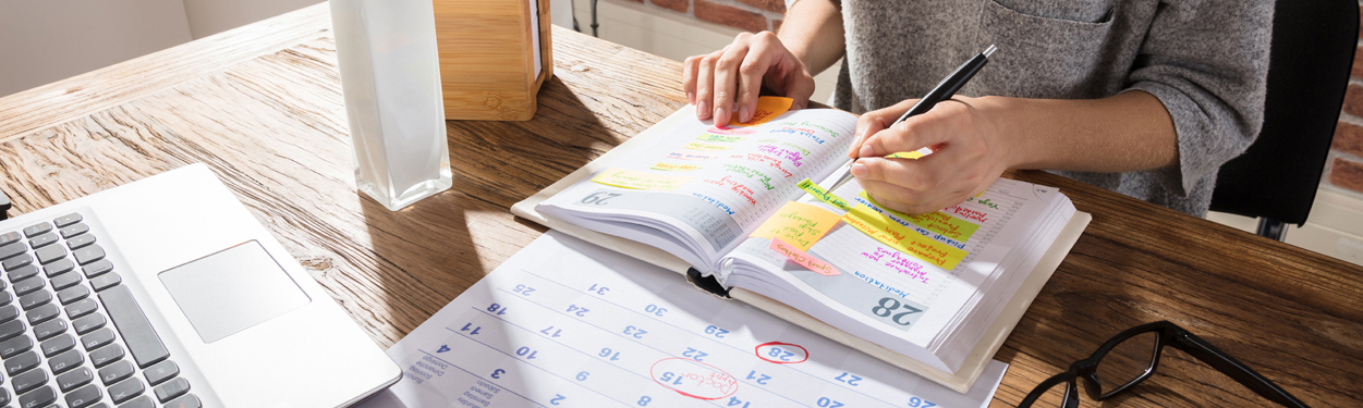 Woman scheduling in calendar
